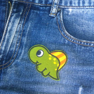 Gullig dinosaurie på jeans - Tygmärke - Patch