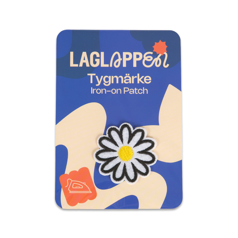 tygmärke blomma
