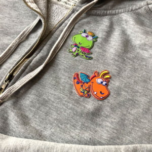 Tygmärke på tröja - grön och orange drake